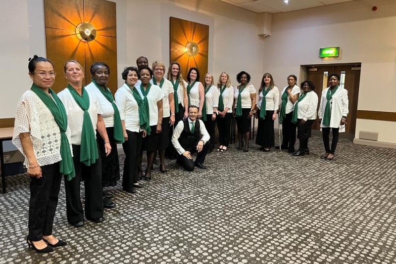 The choir, with Martin Trotman, Choir Director, kneeling